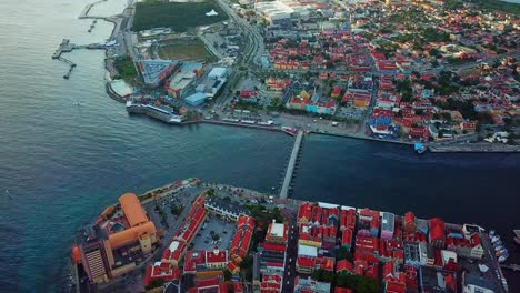 Tilt-down-aerial-view-of-the-districts-of-Punda-and-Otrobanda-in-the-historic-center-of-Willemstad,-capital-of-Curacao,-Dutch-Caribbean-island