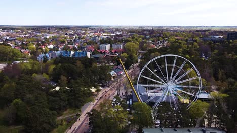 White-Ferris-wheel-under-construction-with-cityscape-of-Palanga,-aerial-view