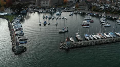 A-wide-shot-of-a-single-yacht-is-sailing-into-harbour-following-a-yachting-competition-on-lake-Geneva