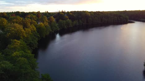 Peaceful-by-the-lake-in-the-most-expensive-area-of-Berlin-Smooth-aerial-view-flight-pedestal-down-drone-footage-of-lake-schlachtensee-summer-sunset-2022-4k-Cinematic-view-from-above-by-Philipp-Marnitz