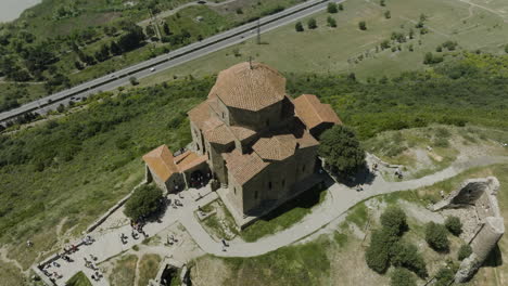 View-from-Above-Of-Clifftop-Orthodox-Jvari-Monastery-With-Overview-Of-Highway-In-Mtskheta,-Georgia