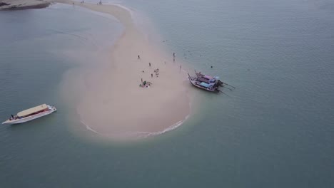 Aerial-View-Of-Tourists-And-Boats-On-A-Private-Island-In-Phuket,-Thailand---drone-shot