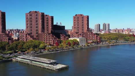 Drone-pull-away-from-apartment-highrise-buildings-along-the-Harlem-River-in-Manhattan,-NYC