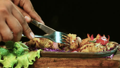Close-Up-Roasted-Chicken-BBQ-With-Male-Hand-Knife-Cutting-Black-Background