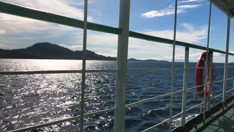 Island-Seascape-View-From-Side-Deck-Of-A-Passenger-Ferry-Navigating-On-A-Sunny-Day-In-Summer