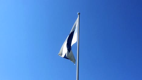 The-flag-of-Finland-waving-in-slow-motion-with-clear-blue-sky-in-the-background