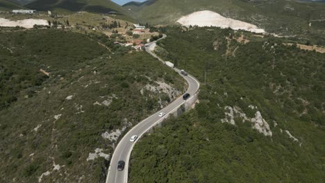 Aerial-View-Of-Cars-Driving-Across-The-Island-Road-In-Zakynthos,-Ionian-Sea,-Greece
