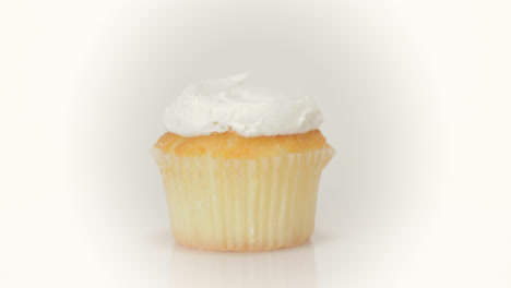 Vanilla-cupcake-rotating-on-a-clean-white-background
