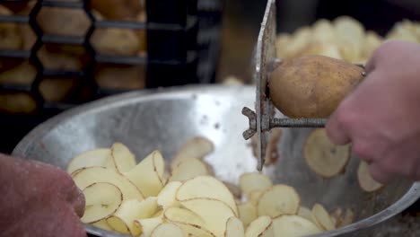 Putting-potato-into-cutter-and-making-tornado-curly-fries-in-slow-motion