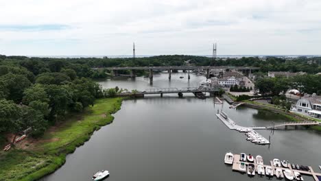 A-high-angle-aerial-view-of-the-Saugatuck-River-in-Westport,-Connecticut-on-a-cloudy-day