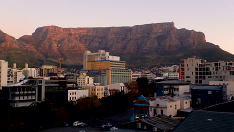 Flat-topped-Table-Mountain-glowing-at-sunset,-towering-over-Cape-Town
