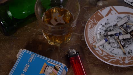 Cards,-gun-and-alcohol-on-a-wooden-table