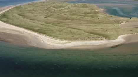 Aerial-view:-Turbulent-outgoing-tide-at-Tramore-sand-dunes,-Ireland