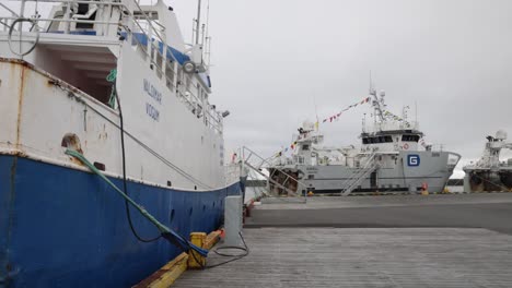 Two-ships-in-port-in-Grindavik,-Iceland-with-gimbal-video-walking-forward