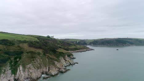 Aerial-tracking-forward-over-the-South-Devon-coastline,-just-visible-is-the-mouth-of-the-River-Dart