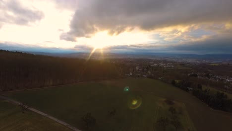 Drone-decend-over-hill-at-sunset