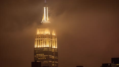 Time-Lapse-of-clouds-at-the-luminous-tower-of-Empire-State-Building-at-a-rainy-night-in-Manhattan,-New-York-City