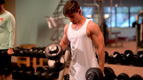 Closeup-of-young-bodybuilder-doing-hammer-curl-exercises-with-heavy-dumbbells