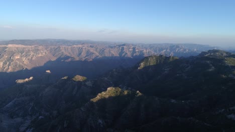 Aerial-jib-down-shot-of-the-epic-Urique-Canyon-at-sunset-in-Divisadero,-Copper-Canyon-Region,-Chihuahua
