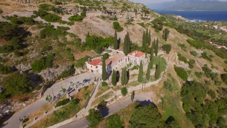 Aerial:-A-monastery-and-caves-in-the-mountains-of-Samos,-Greece