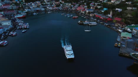 Drone-shot-of-a-Ferry-leaving-port-on-St-George,-Grenada