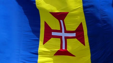 Close-up-national-flag-of-the-Autonomous-Region-of-Madeira-blowing-in-the-wind,-Madeira-an-archipelago-in-the-north-Atlantic-Ocean,-southwest-Portugal