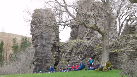 Lunch-break-for-a-group-of-ramblers-at-the-ruins-of-Pendragon-castle-which-reputed-to-have-been-founded-by-Uther-Pendragon,-the-father-of-King-Arthur,-situated-in-the-Mallerstang-Valley-Cumbria