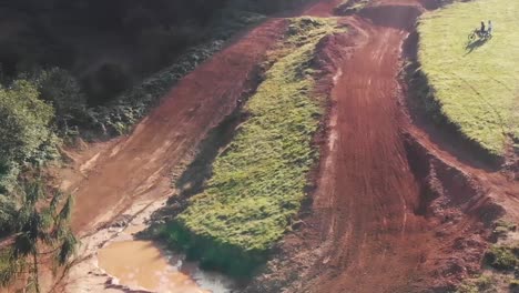 Drone-shot-of-motocross-park-with-rider-jumping-over-a-big-jump