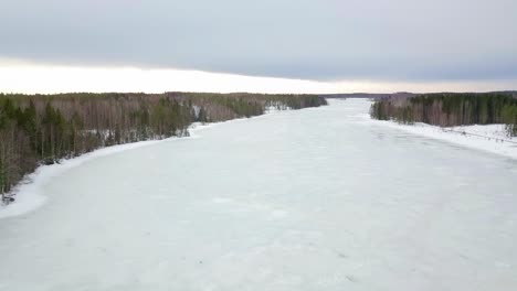 Aerial-drone-shot-of-frozen-winter-lake