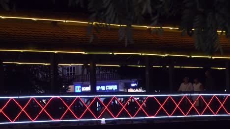 Tourist-Walking-on-a-Illuminated-Bridge