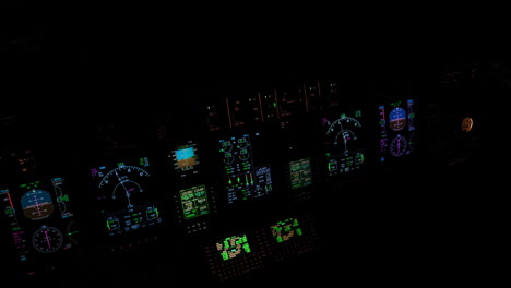 Beleuchtete-Instrumente-Und-Avionik-Eines-Flugzeugdecks-In-Einem-Pechschwarzen-Cockpit