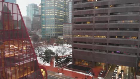Aerial-footage-of-buildings-at-downtown-Minneapolis-during-a-rainy-day,-camera-going-backward