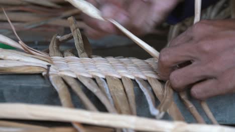 Close-Shot-of-a-Woman-Weaving-Palm-Tree-Leaf