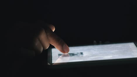 Close-Shot-of-Somebody-Using-a-Tablet-at-Night