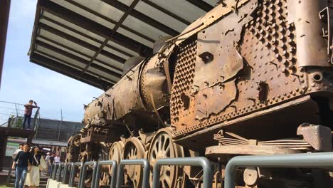 A-couple-of-lovers-watch-the-wreckage-of-a-train-bombed-during-the-Korean-war-displayed-at-Imjingak-by-the-DMZ-overlooking-North-Korea,-in-Munsan,-Paju,-Gyeonggi-do,-South-Korea