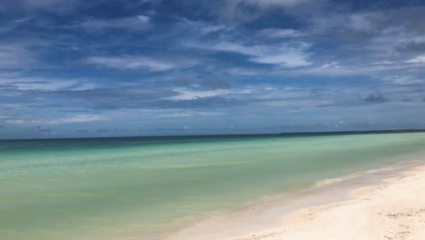 Camera-pan-along-deserted-caribbean-white-sandy-beach