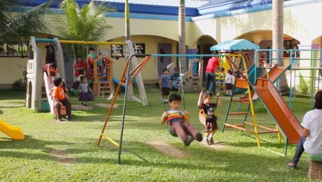 Preschool-kids-at-a-private-nursery-school-in-Cebu-City,-Philippines-enjoying-their-favorite-time-of-day-at-the-school-playground
