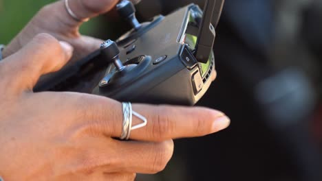 Close-Shot-of-a-Woman-Using-a-Drone-Controller