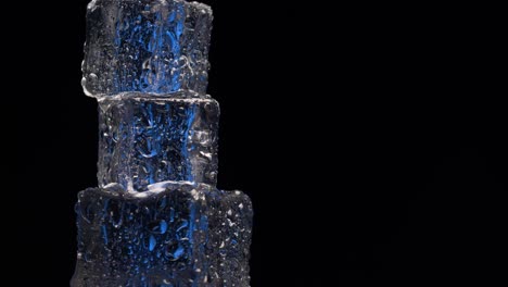 Close-up-ice-cubes-rotating-on-black-background