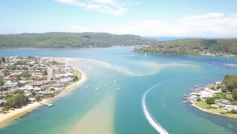Aerial-drone-video-footage-of-white-sands-blue-water-beach-over-a-speed-boat-in-Sydney-Australia