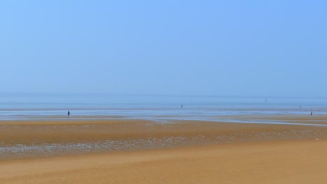 Camera-pan-right-to-left-vast-wide-open-empty-beach-blue-sky-and-ocean