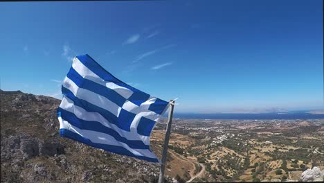 Flag-of-Greece-on-the-fortress-of-Paleo-Pili-an-historical-site-on-the-island-of-Kos-in-Greece