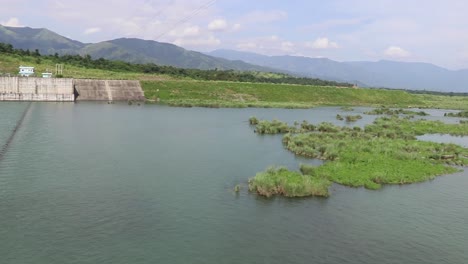 Footage-of-water-flow-of-dam-reservoir-of-National-Irrigation-Authority-built-to-produce-hydroelectric-energy-in-San-Roque-Dam,-in-Pangasinan,-Philippines