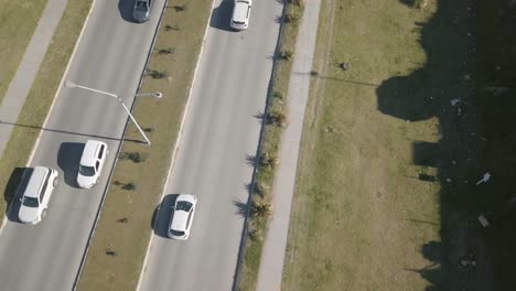 Aerial-Drone-shot-looking-vertically-down-highway-with-cars-going-through