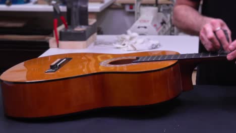 Man-assembling-acoustic-guitar.-Fast-motion