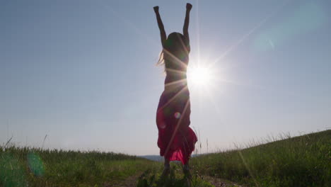 a-woman-jumping-in-the-air-in-front-of-the-sun