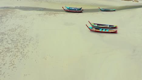 Aerial-view-or-top-view-of-long-tailed-boat-is-floating-on-the-emerald-sea