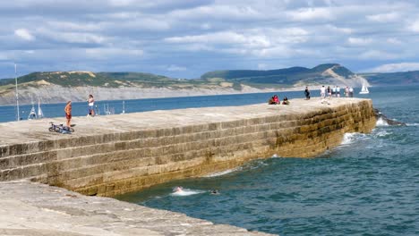 A-young-man-jumps-off-of-the-Cobb-at-Lyme-regis-into-the-sea