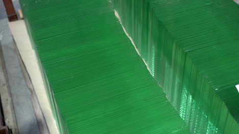 Two-rows-of-small-green-glass-squares-in-the-warehouse