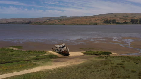 Drone-flying-by-old-shipwreck-in-Point-Reyes-near-Inverness,-California,-day-time